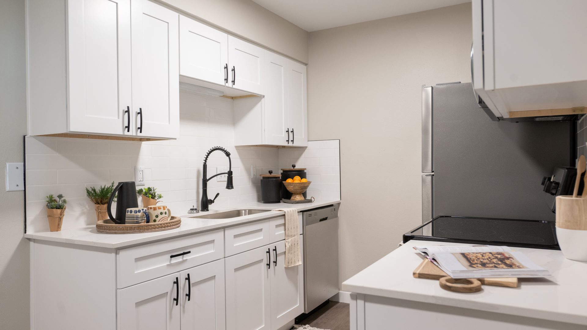 a kitchen with white cabinets and white appliances