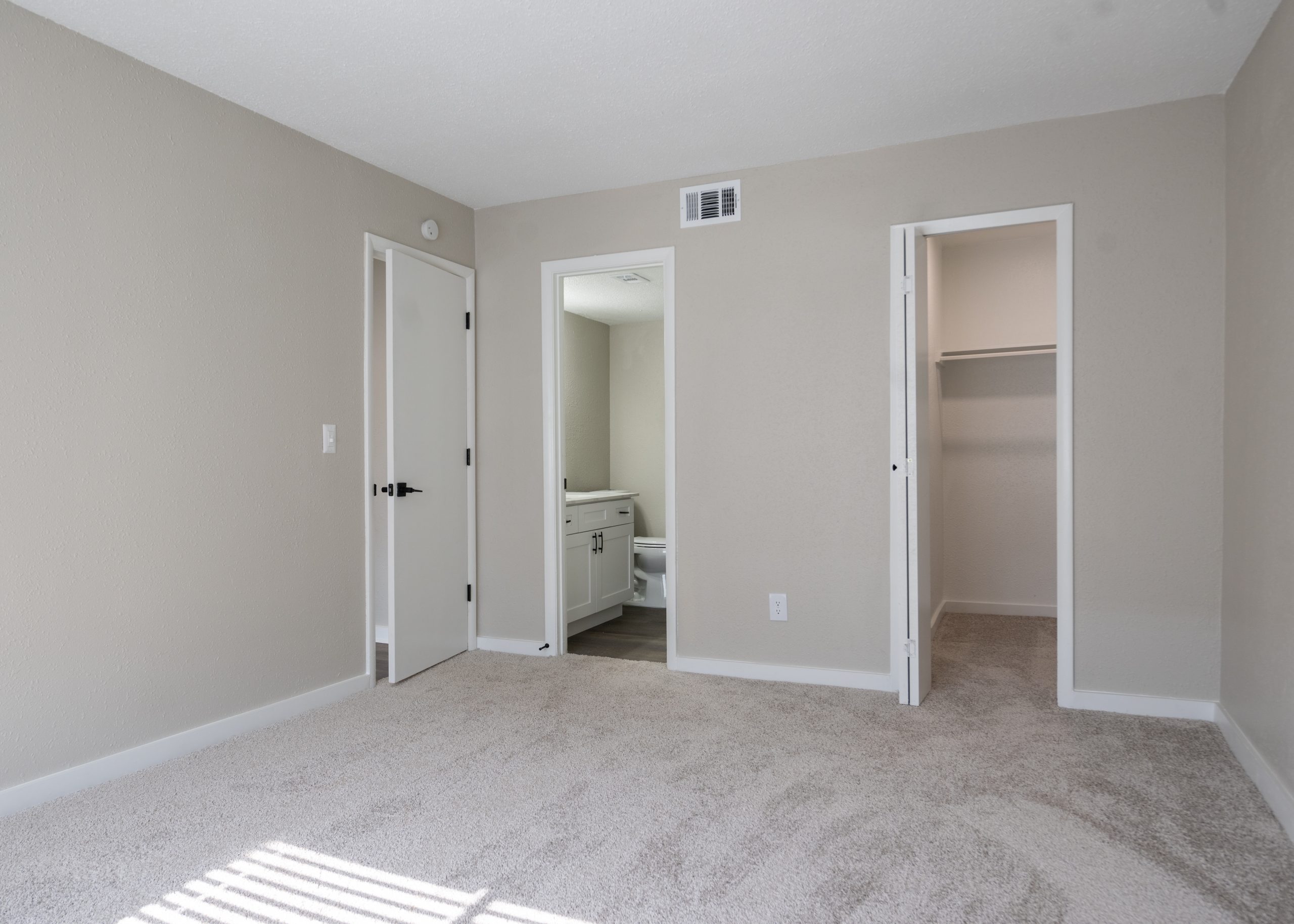 a room with a white door and a white wall