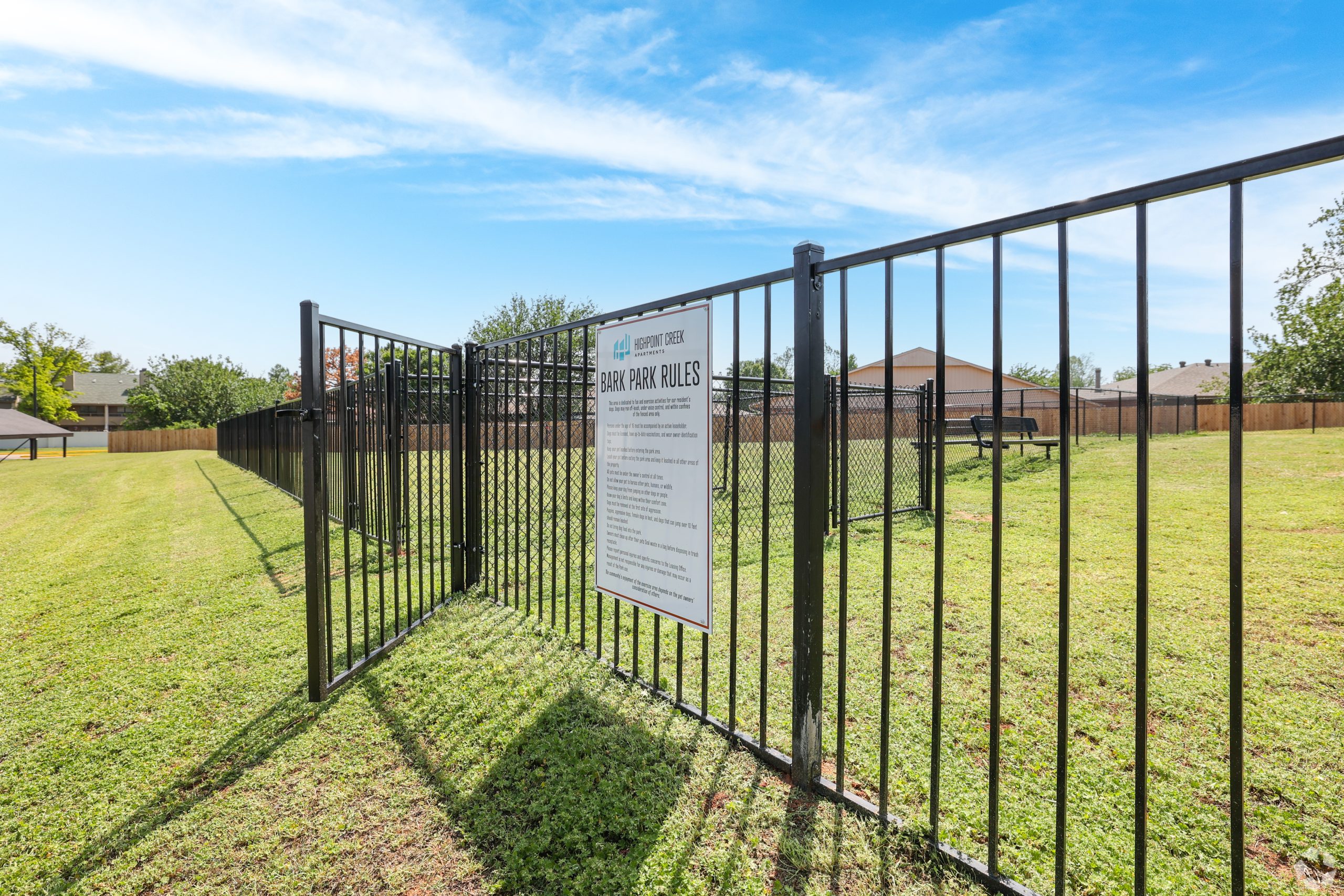 a fence that is in the grass near a fence