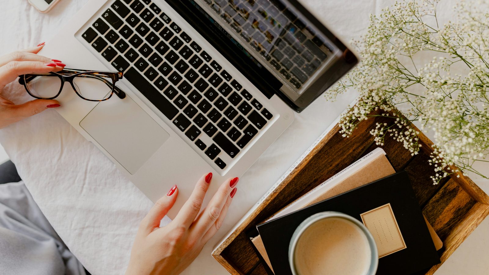 a woman's hand on a laptop