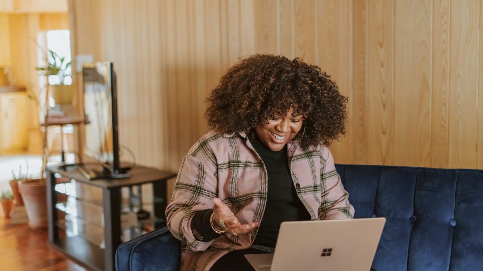 person sitting on couch holding a Surface device