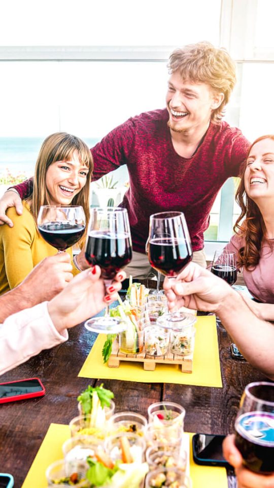 group of friends toasting wine at a restaurant at The  Apiary
