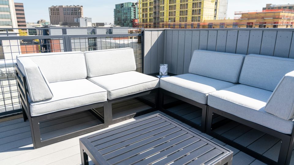 Rooftop patio furniture offers a relaxing city view.