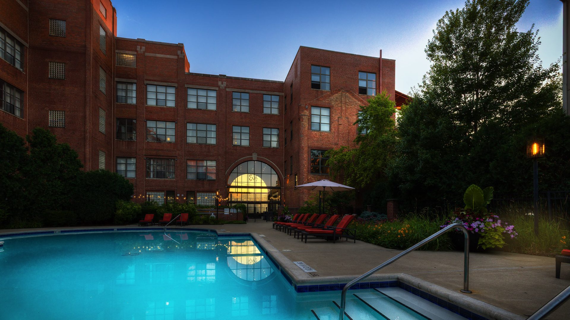 a large swimming pool with a balcony in front of it