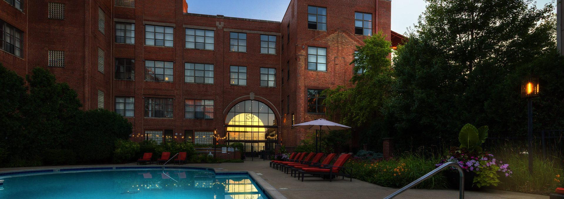 a large swimming pool with a balcony in front of it