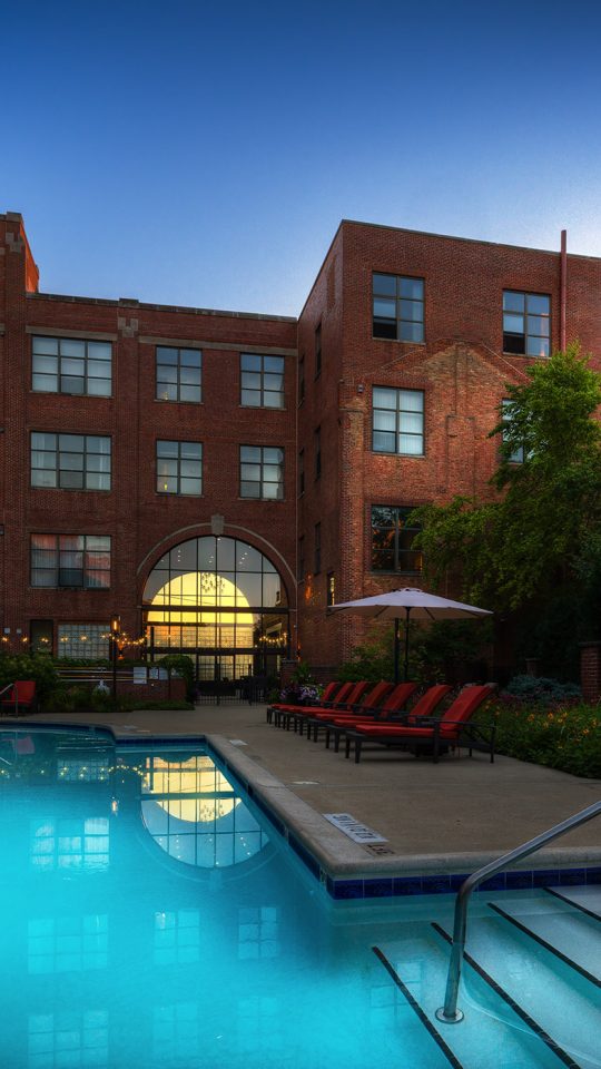 a large swimming pool with a balcony in front of it