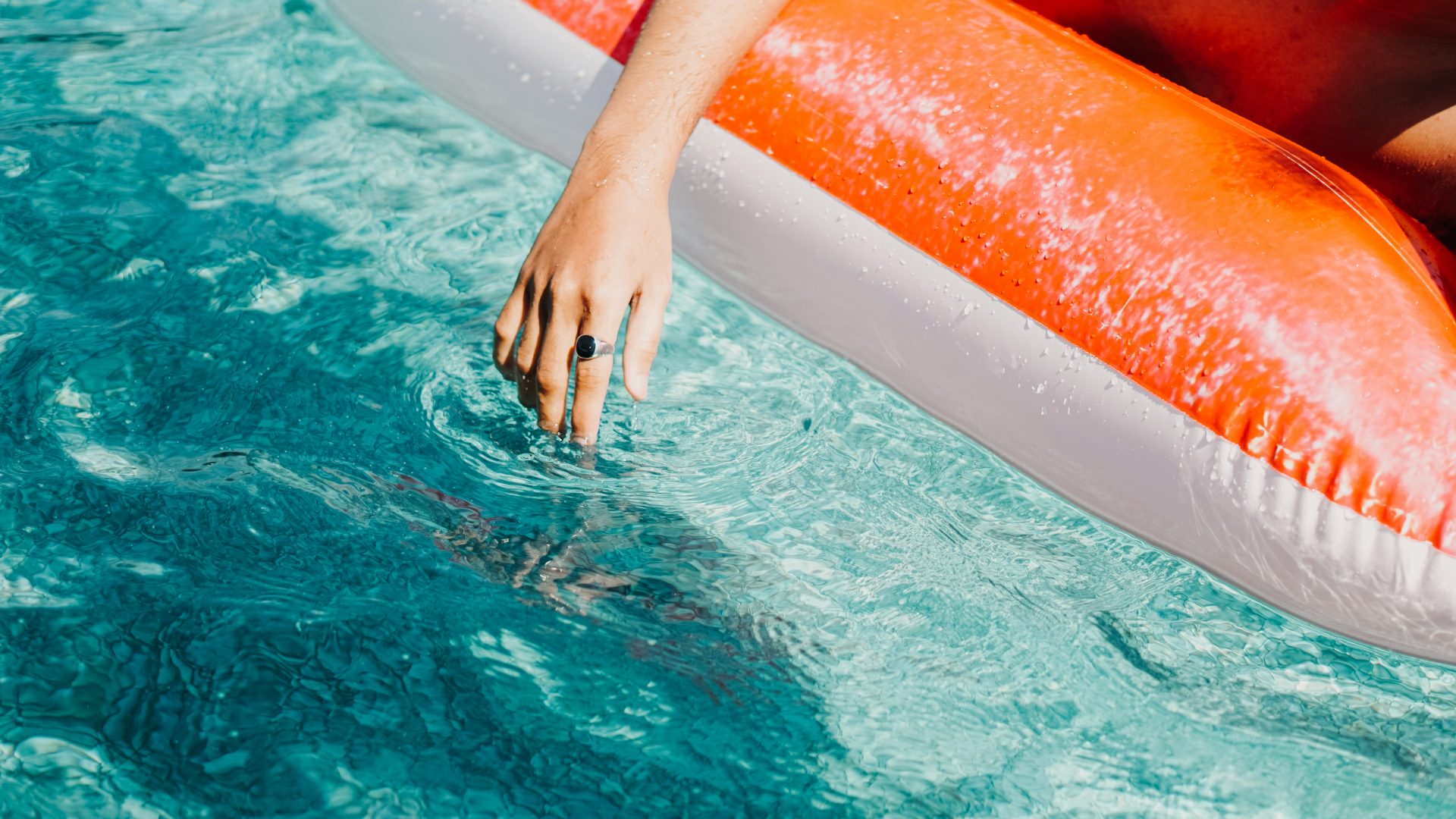 a person is floating in a pool with an inflatable raft