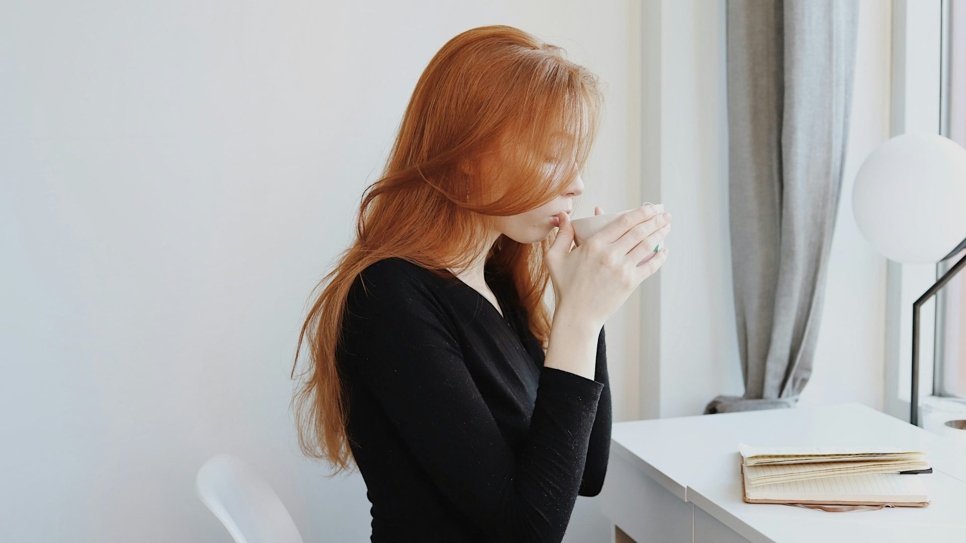 woman in black long sleeve shirt sitting on chair