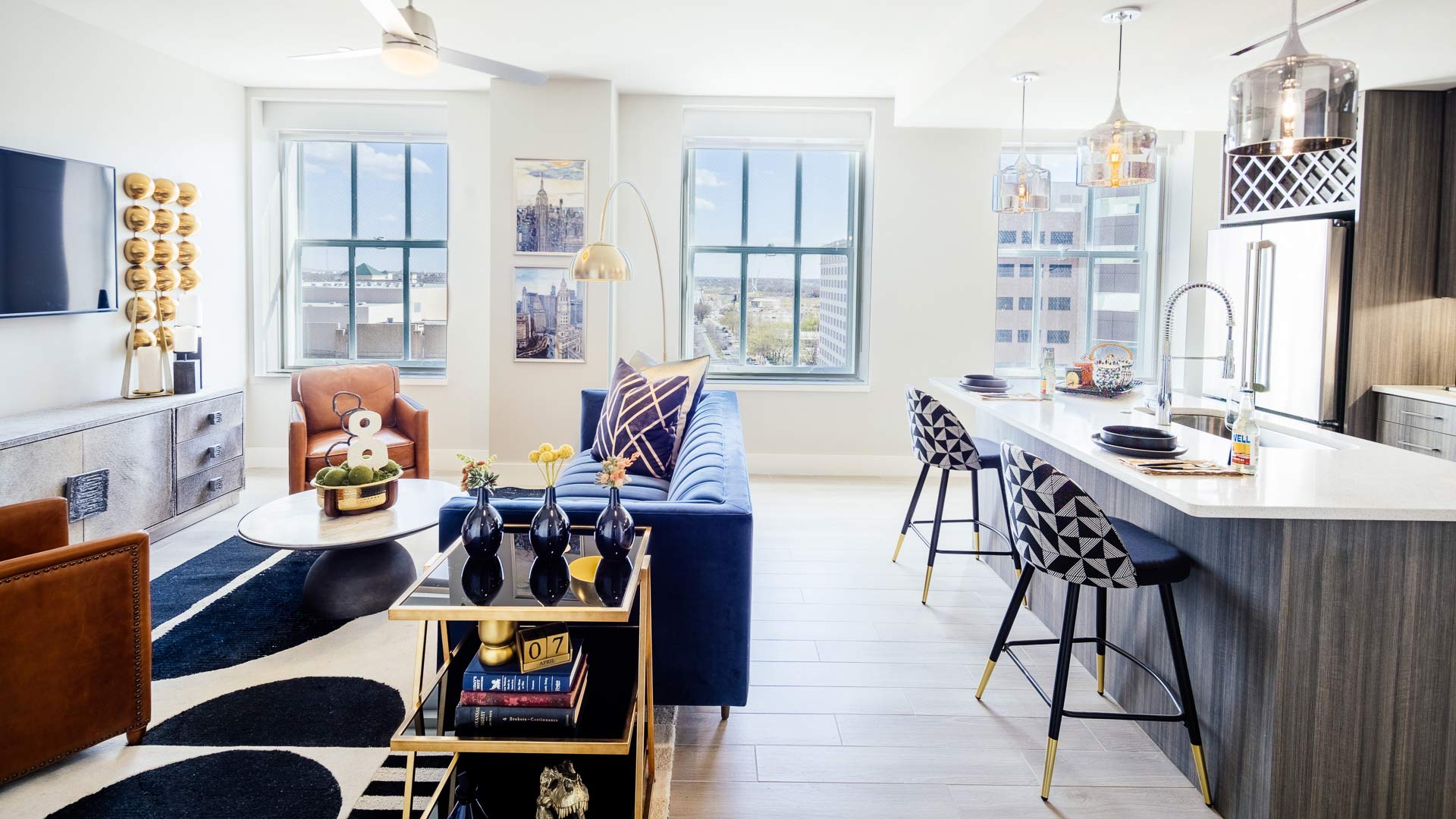 a living room with a blue couch and a white table at The  First