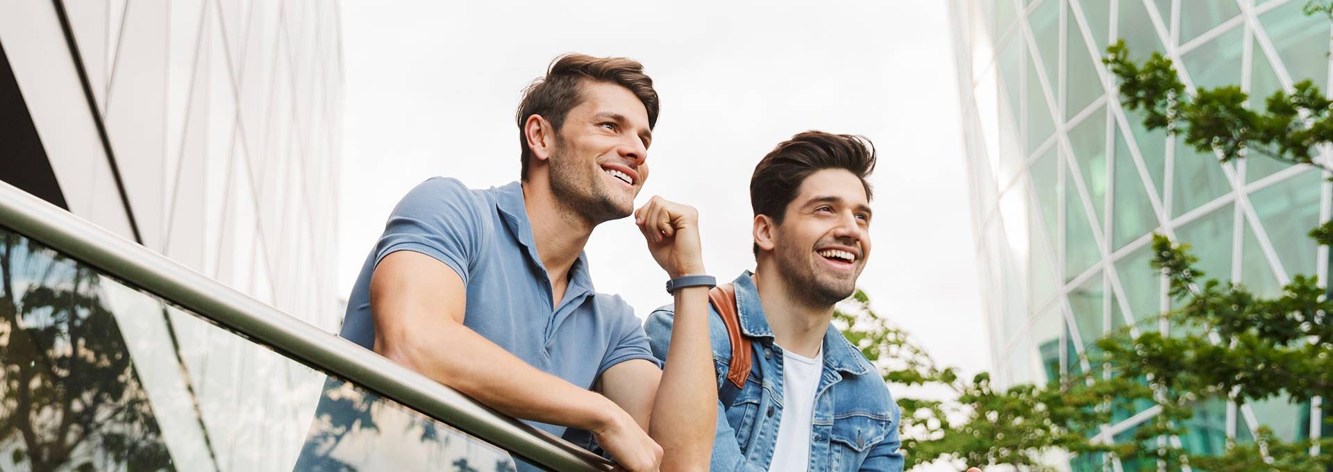 Two happy friends standing in the balcony