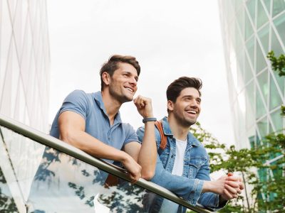 Two happy friends standing in the balcony