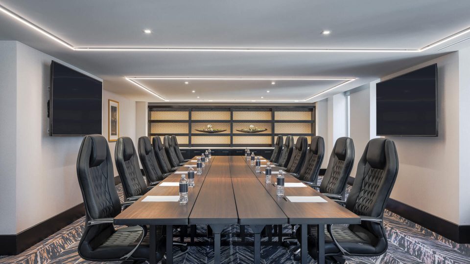 a conference room with a large table and chairs at The First