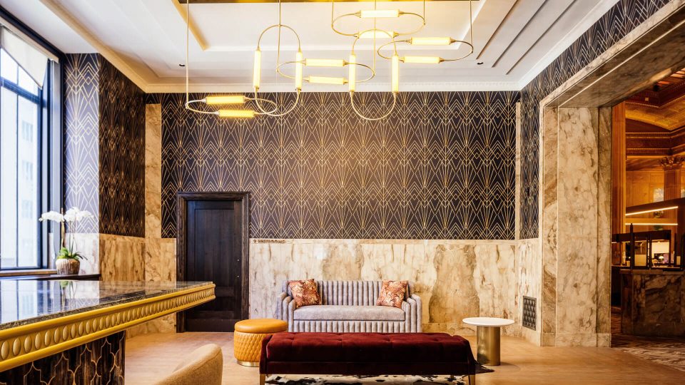 the lobby of a hotel with a marble floor at The First