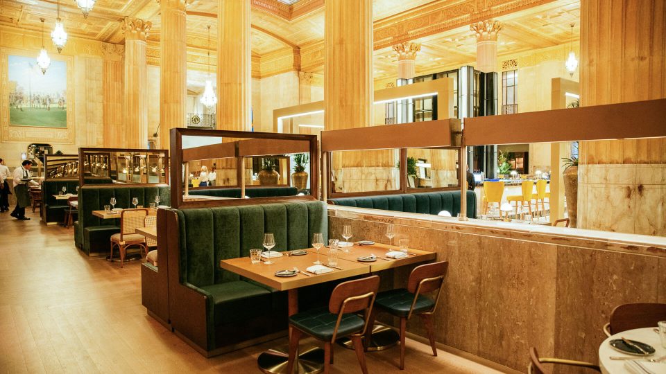 a restaurant with wooden tables and benches at The First