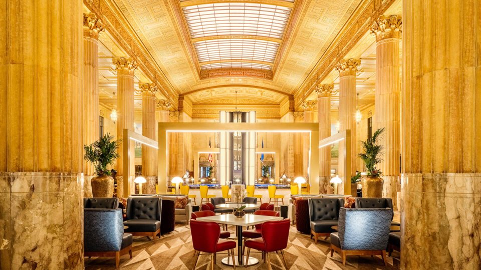 the lobby of a hotel with a large chandelier at The First