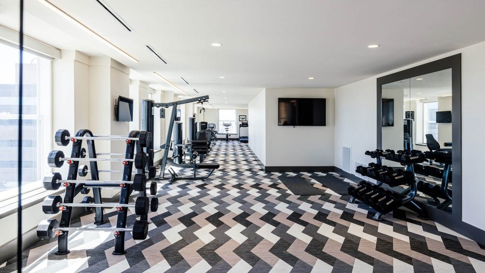 a gym room with a black and white checkered floor at The First