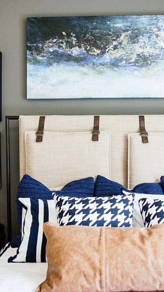 a bedroom with a bed, nightstands, and pictures on the wall at The First