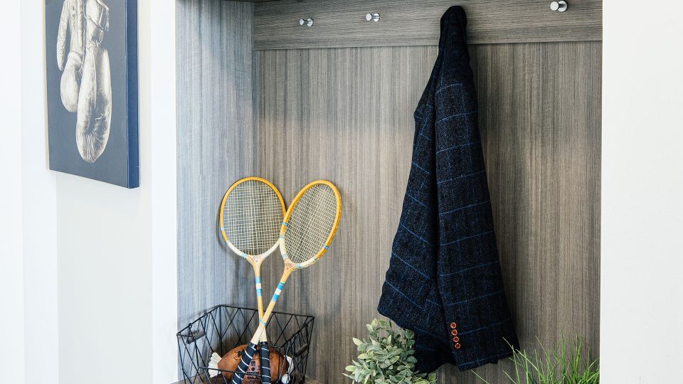 a tennis racket and tennis balls are displayed in a cabinet at The First