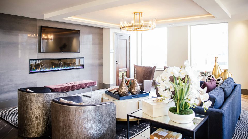 a living room with a fireplace and a television at The First