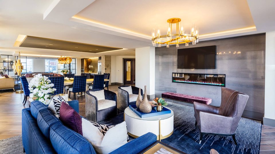 the living room features a large flat screen tv and a fireplace at The First