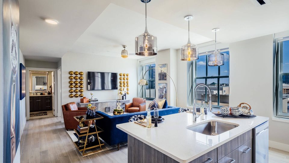 a kitchen and living room with a large window at The First