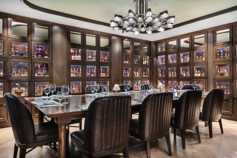 a dining room with a large table and chairs at Stock and Bond OKC