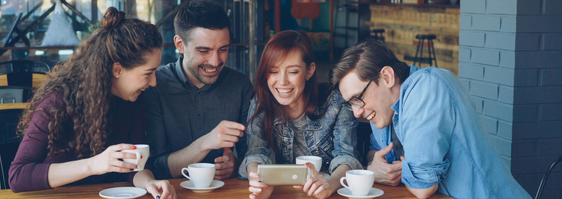 A group of friends laughing together over coffee