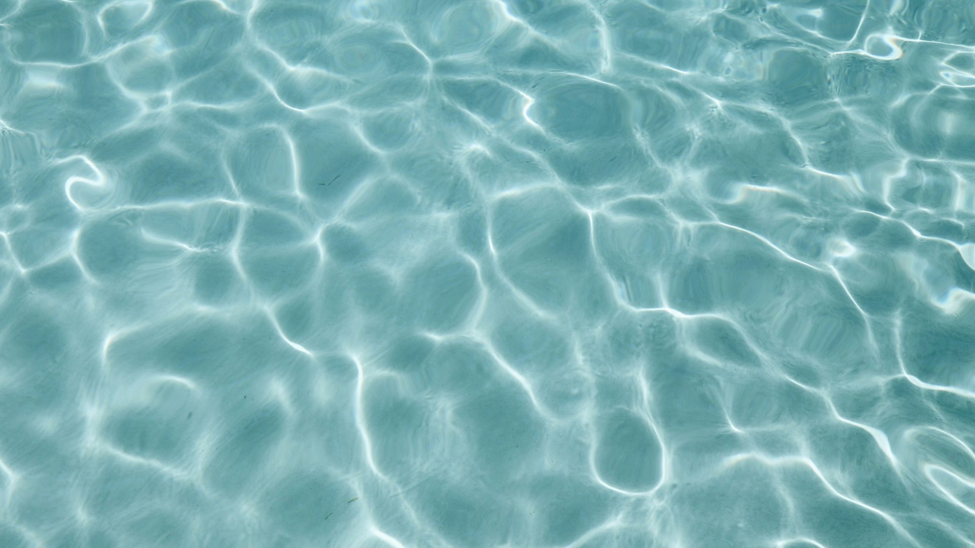 Close-up of sparkling blue pool water