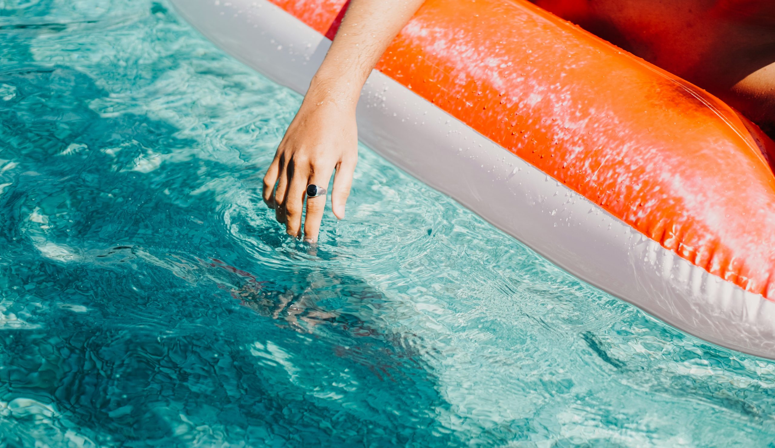 a person is floating in a pool with an inflatable raft