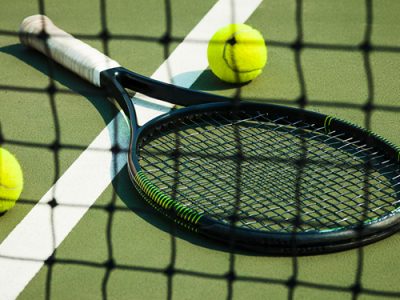 Badminton racket on tennis court