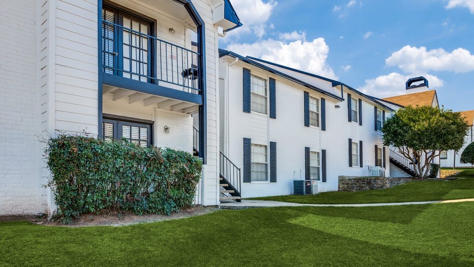 Walksways surrounded by green area between buildings