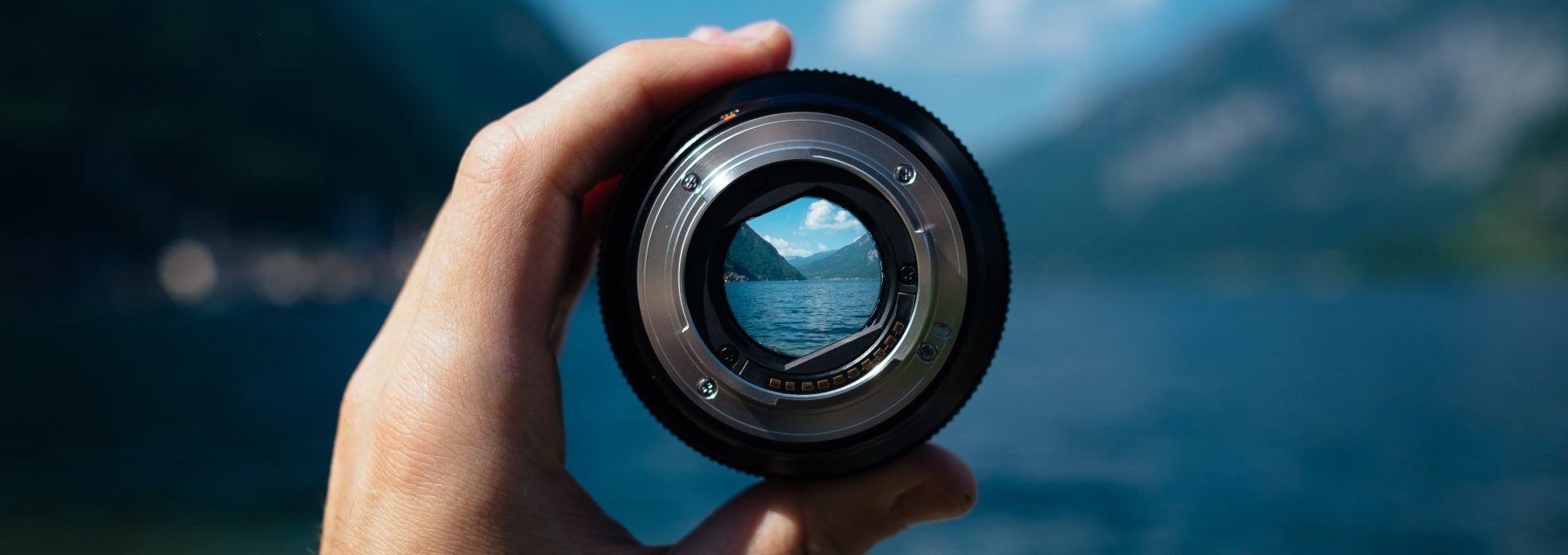 person holding camera lens