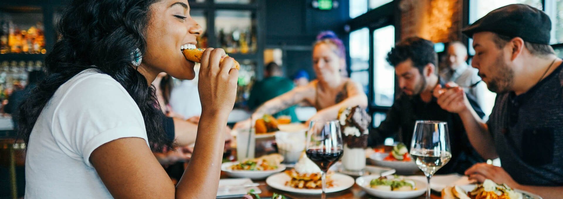 people eating food at a restaurant table at The Breezeway Townhomes