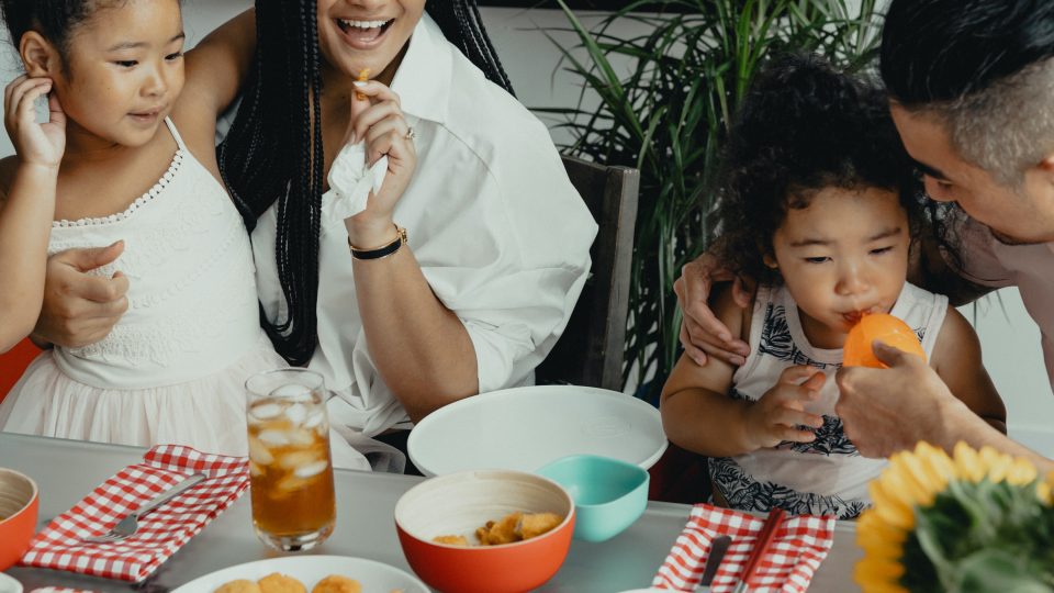 a family eating food together at a table at The Breezeway Townhomes