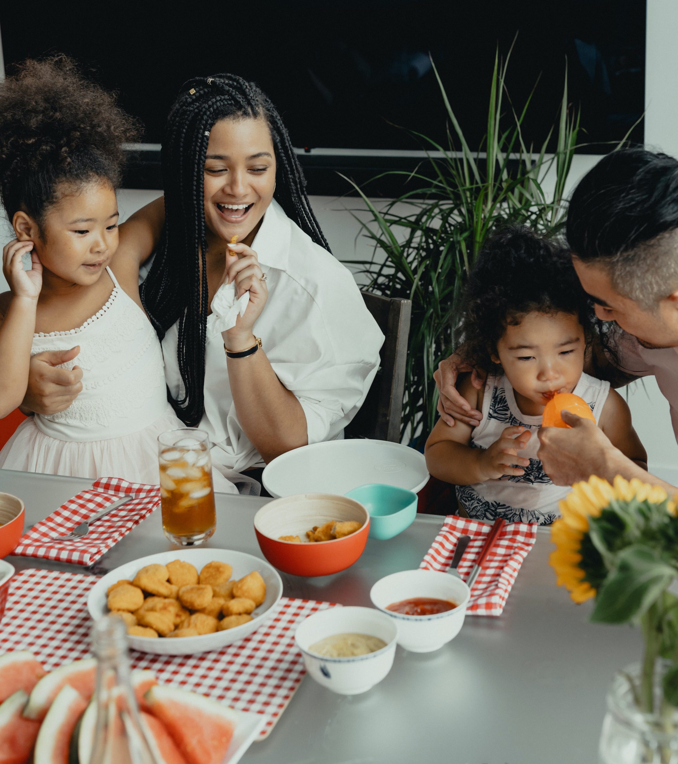 a family eating food together at a table at The Breezeway Townhomes