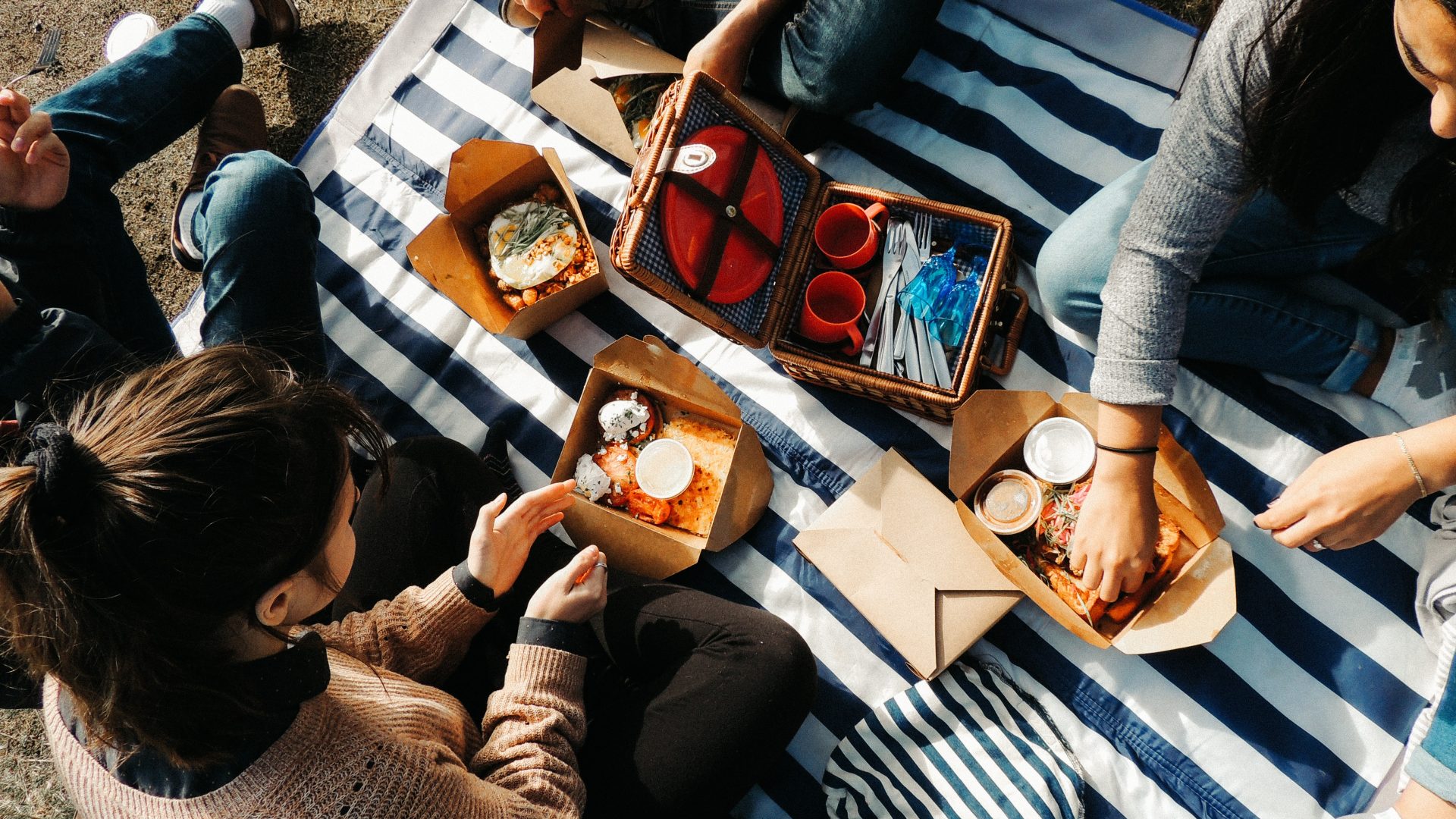 woman in gray sweater sitting beside man in black and white stripe shirt