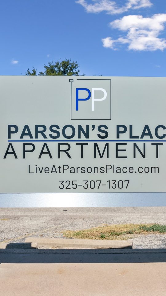 a sign for parsons place apartments with a blue sky at The Parsons Place
