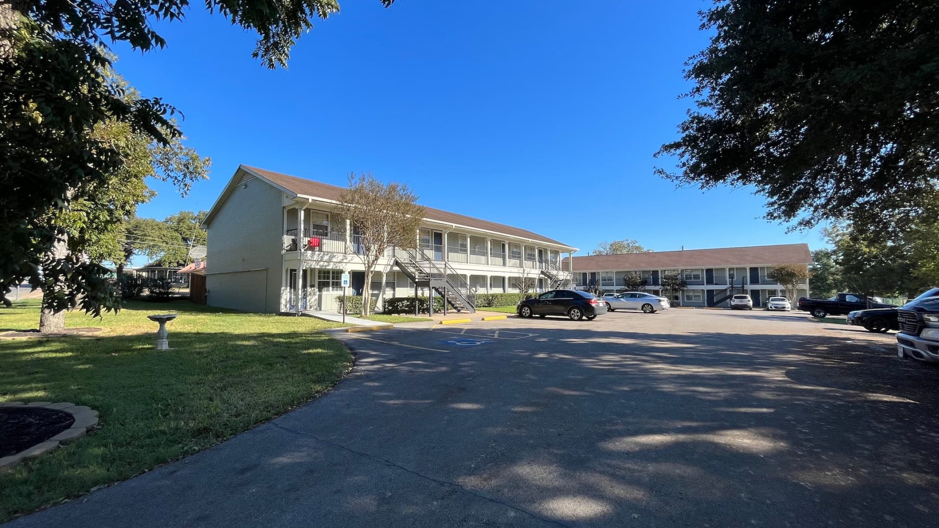 the motel is located on a street with cars parked in front at The North Park Apartments