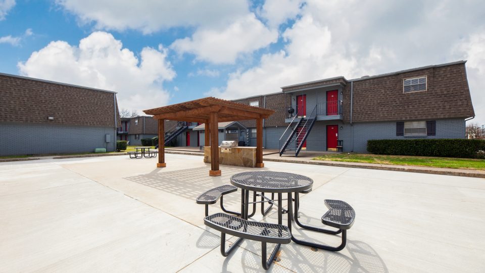 outdoor grill space with pergola and picnic table