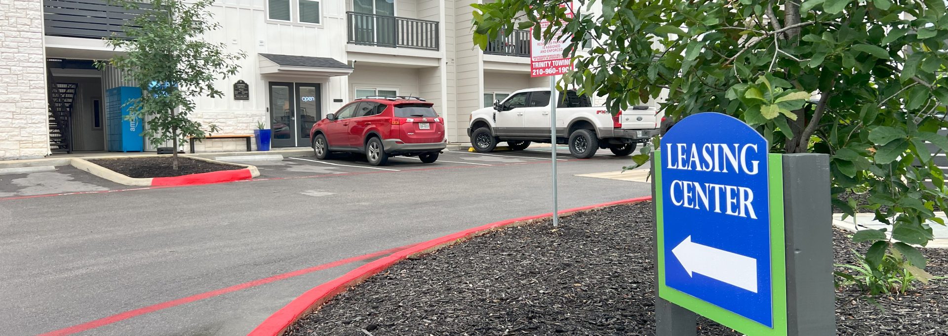 a sign for the leasing center at The Garden Creek Apartments