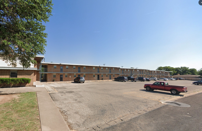 the parking lot of a motel with cars parked in front at The Legacy Terrace