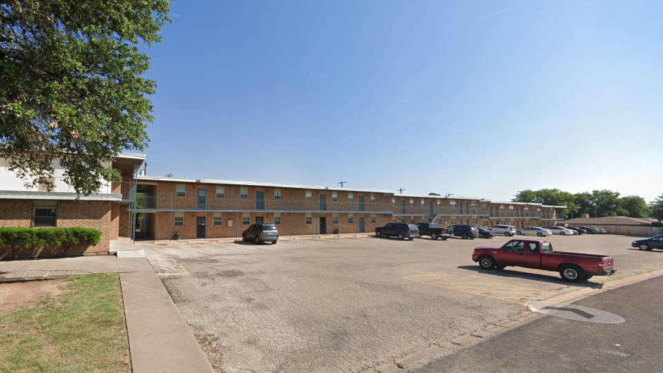 the parking lot of a motel with cars parked in front at The Legacy Terrace