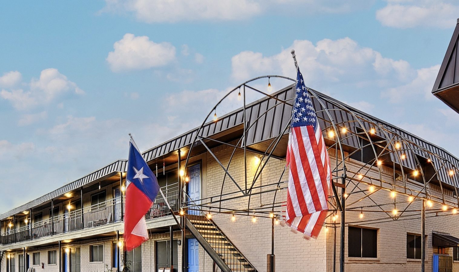 the texas flag is flying outside of a motel at The Choir