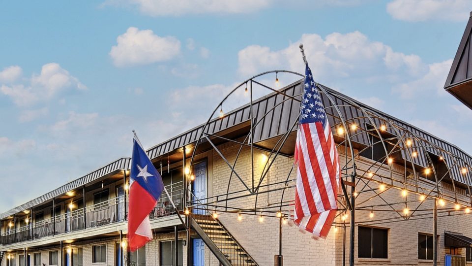 the texas flag is flying outside of a motel at The  Choir