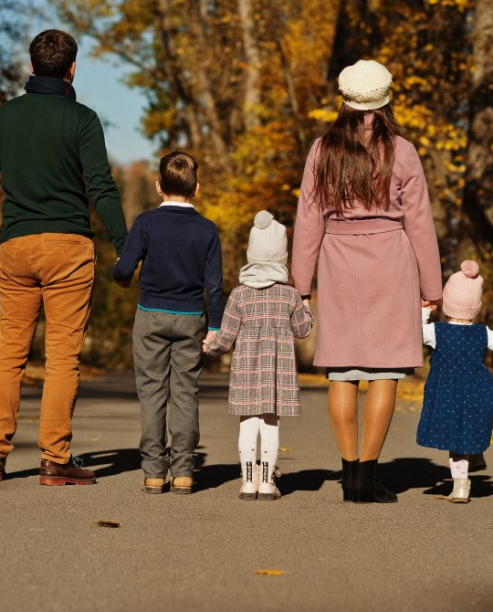 a family walking down a road in the fall at The  Choir