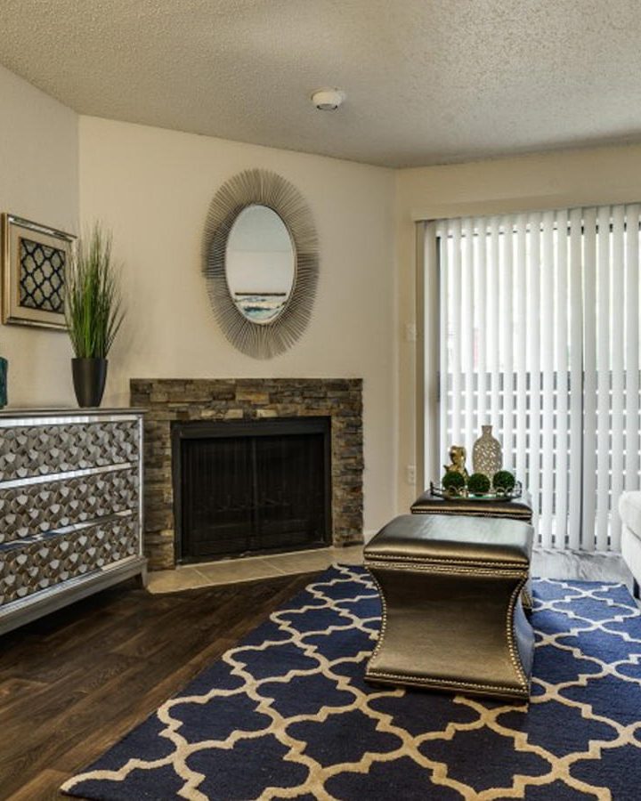 the living room has a fireplace and a rug at The Hudson