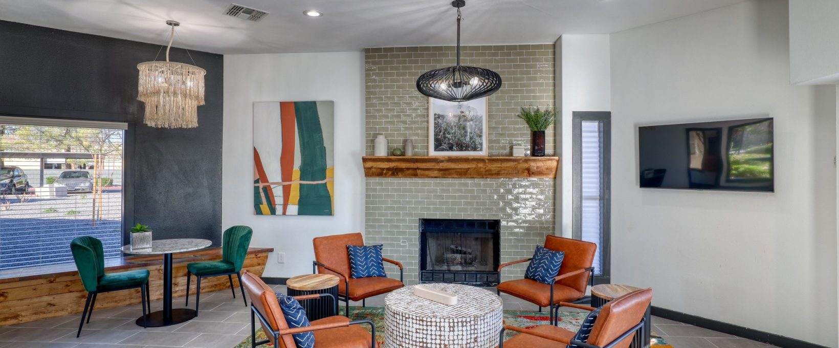 the living room features a fireplace, chairs and a television at The Jerome