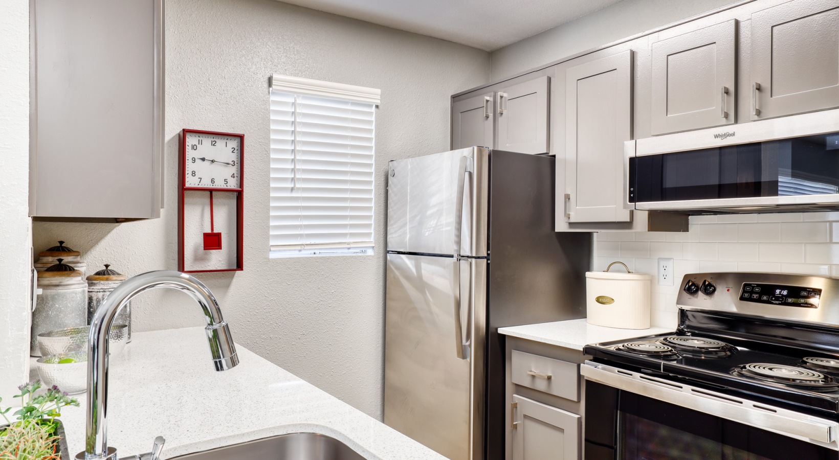 a kitchen with stainless steel appliances and a sink at The Jerome