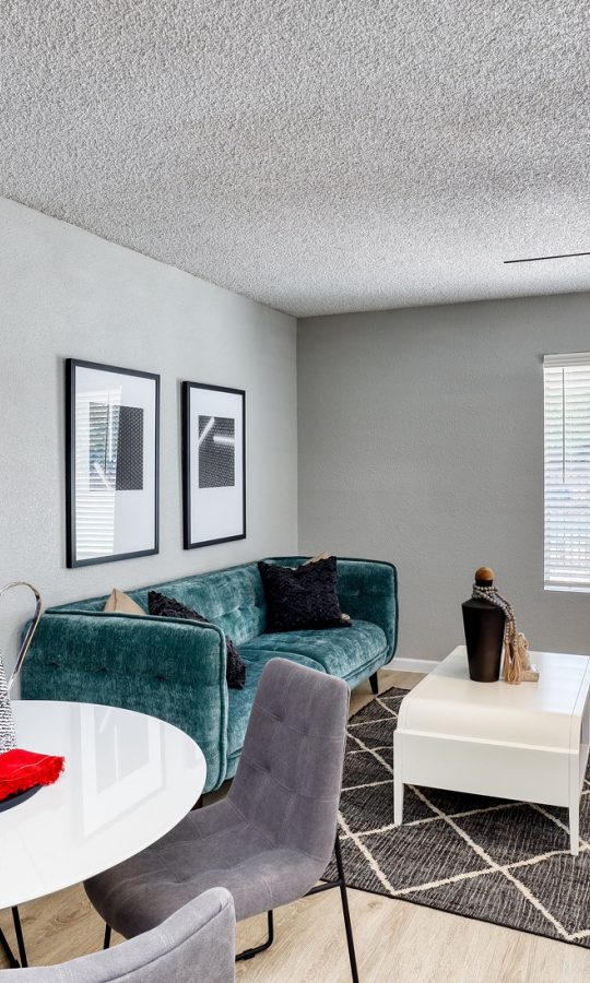 a living room with a dining table and chairs at The Jerome