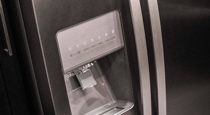 a black refrigerator with a water dispenser at The Live Oak at  Branch